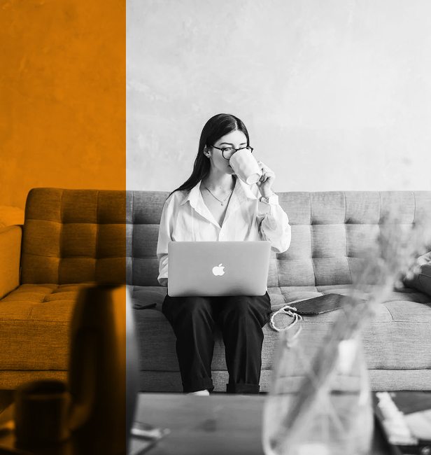 a woman is drinking coffee while working
